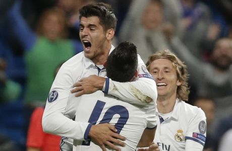 Real Madrid players Luka Modric, right, and James Rodriguez, front, hug Alvaro Morata, left, who scored 2-1 during a Champions League, Group F soccer match between Real Madrid and Sporting, at the Santiago Bernabeu stadium in Madrid, Spain, Wednesday, Sept. 14, 2016. (AP Photo/Daniel Ochoa de Olza)