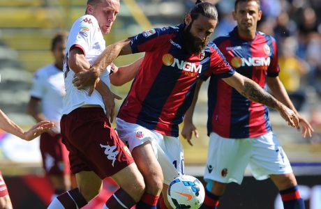 Bologna's Davide Moscardelli, right, is challenged by Torino's Kamil Glik during their Serie A soccer match at the Bologna Renato Dall'Ara stadium, Italy, Sunday, Sept. 22, 2013 (AP Photo/Paolo Ferrari)