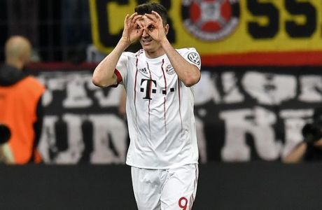 Bayern's Robert Lewandowski celebrates after he scored his side's second goal during the German soccer cup semifinal match between Bayer Leverkusen and Bayern Munich in Leverkusen, Germany, Tuesday, April 17, 2018. (AP Photo/Martin Meissner)
