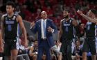 Memphis head coach Penny Hardaway, middle, talks to his players guard Kareem Brewton Jr. (5), guard Raynere Thornton (4) and forward Kyvon Davenport (0) after a time out during the second half of an NCAA college basketball game against Houston Sunday, Jan. 6, 2019, in Houston. (AP Photo/Michael Wyke)