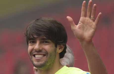 FILE-In this Friday, Oct. 10, 2014 file photo, Brazil's Kaka waves as he arrives for a training session ahead of a friendly match against Argentina at the Bird's Nest National Stadium in Beijing, China. Former Ballon dOr winner Kaka says he is retiring from soccer at age 35, it was reported on Sunday, Dec. 17, 2017. (AP Photo/Ng Han Guan, File)