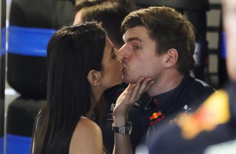 Red Bull driver Max Verstappen of the Netherlands gets a kiss from Kelly Piquet before the third practice session for the Formula One Miami Grand Prix auto race at the Miami International Autodrome, Saturday, May 7, 2022, in Miami Gardens, Fla. (AP Photo/Darron Cummings)