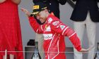 Ferrari driver Sebastian Vettel of Germany celebrates on the podium after winning the Formula One Grand Prix at the Monaco racetrack in Monaco, Sunday, May 28, 2017. (AP Photo/Frank Augstein)