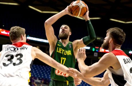 Lithuania's Jonas Valanciunas, centre, goes to the basket between Germany's Patrick Heckmann, left, and Danilo Barthel during their Eurobasket European Basketball Championship Group B match in Tel Aviv, Israel, Wednesday, Sept. 6, 2017. (AP Photo/Ariel Schalit)