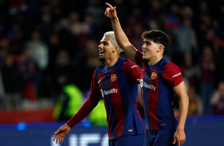 Barcelona's Pau Cubarsi, right, and Barcelona's Ronald Araujo celebrate after the Champions League, round of 16, second leg soccer match between FC Barcelona and SSC Napoli at the Olympic Stadium in Barcelona, Spain, Tuesday, March 12, 2024. (AP Photo/Joan Monfort)