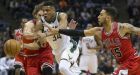 Chicago Bulls' Robin Lopez, left, and Denzel Valentine try to stop Milwaukee Bucks' Giannis Antetokounmpo during the first half of an NBA basketball game, Sunday, March 26, 2017, in Milwaukee. (AP Photo/Tom Lynn)