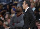 Cleveland Cavaliers head coach David Blatt, front, looks on as Cleveland Cavaliers forward LeBron James (23) waits to enter in the first half of an NBA basketball game Tuesday, Dec. 29, 2015, in Denver. (AP Photo/David Zalubowski)