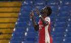 Arsenal's Bukayo Saka celebrates after scoring his sides 4th goal of the game during the English Premier League soccer match between Chelsea and Arsenal at Stamford Bridge in London, Wednesday, April 20, 2022. Arsenal won the match 4-2. (AP Photo/Frank Augstein)