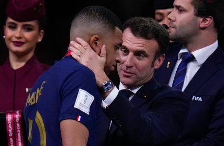 France's Kylian Mbappe is consoled by French President Emmanuel Macron after the World Cup final soccer match between Argentina and France at the Lusail Stadium in Lusail, Qatar, Sunday, Dec.18, 2022. (AP Photo/Manu Fernandez)