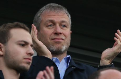 Chelsea's Russian owner Roman Abramovich applauds his players after they defeated Arsenal 6-0, in the English Premier League soccer match between Chelsea and Arsenal at Stamford Bridge stadium in London Saturday, March 22,  2014. (AP Photo/Alastair Grant)