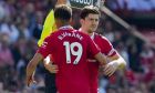Manchester United's Harry Maguire, right, walks in as substitute for Manchester United's Raphael Varane during the English Premier League soccer match between Manchester United and Wolverhampton at the Old Trafford stadium in Manchester, England, Saturday, May 13, 2023. (AP Photo/Jon Super)