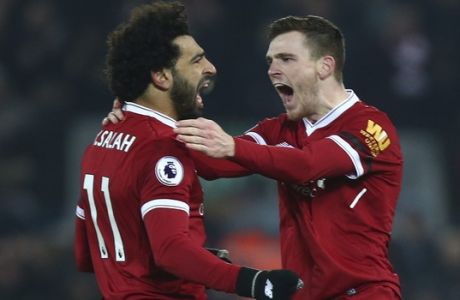 Liverpool's Andrew Robertson, right, celebrates with Mohamed Salah after Salah scored his side's fourth goal during the English Premier League soccer match between Liverpool and Manchester City at Anfield Stadium, in Liverpool, England, Sunday Jan. 14, 2018. (AP Photo/Dave Thompson)