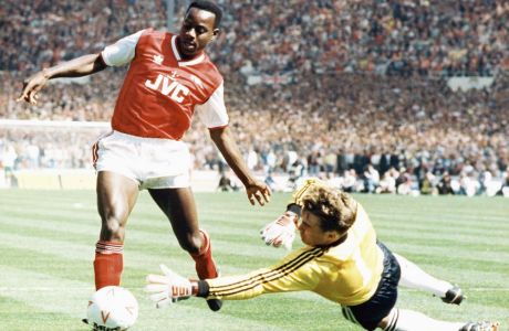 Luton Towns goalkeeper Andy Diddle is at full stretch as he pushes the ball away from the feet of Arsenals Michael Thomas during the final of the Littlewoods Challenge Cup Final at Wembley Stadium in London,, April 24, 1988. A last minute goal by Lutons Brian Stein gave them victory by three goals to two over Arsenal, who were defending the up they won last season. (AP Photo)