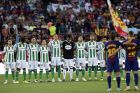 Betis and Barcelona players observe a minute of silence for the victims of the van attacks before a La Liga soccer match between Barcelona and Betis at the Camp Nou stadium in Barcelona, Spain, Sunday, Aug. 20, 2017. Security was stepped up for the match after a terror attack that killed 14 people and wounded over 120 in Barcelona and police put up scores of roadblocks across northeast Spain on Sunday in hopes of capturing a fugitive suspect at large following the vehicle attack. Barcelona players are all wearing shirts with 'Barcelona' on their backs tonight, rather than their names to pay homage to the van attack victims. (AP Photo/Manu Fernandez)