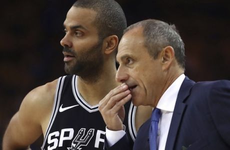 San Antonio Spurs acting coach Ettore Messina, right, speaks with Tony Parker during the first quarter in Game 5 of a first-round NBA basketball playoff series against the Golden State Warriors on Tuesday, April 24, 2018, in Oakland, Calif. (AP Photo/Ben Margot)
