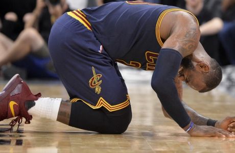 Cleveland Cavaliers forward LeBron James falls to the floor during the second half of an NBA basketball game against the San Antonio Spurs, Monday, March 27, 2017, in San Antonio. (AP Photo/Darren Abate)