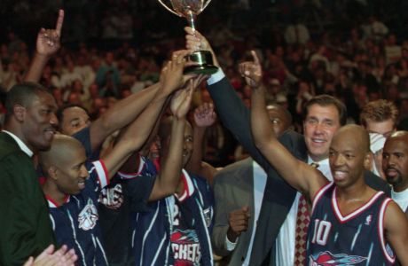 The Houston Rockets hold up the McDonalds Basketball tournament cup in the London Arena after they beat Italy's, Vitus Buckler Bologna in the finals Saturday Oct. 21, 1995. At left Hakeem Olajuwon who did not play due to injury, No 10 is Sam Cassell. (AP Photo/ Max Nash)