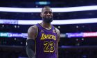 Los Angeles Lakers forward LeBron James (23) in between a play during the second half of an NBA basketball game against the New Orleans Pelicans on Friday, Feb. 9, 2024, in Los Angeles. (AP Photo/Yannick Peterhans)