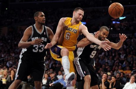 LOS ANGELES, CA - APRIL 17:  Josh McRoberts #6 of the Los Angeles Lakers goes for a rebound between Tony Parker #9 and Boris Diaw #33 of the San Antonio Spurs during the game at Staples Center on April 17, 2012 in Los Angeles, California.  NOTE TO USER: User expressly acknowledges and agrees that, by downloading and or using this photograph, User is consenting to the terms and conditions of the Getty Images License Agreement.  (Photo by Harry How/Getty Images)
