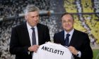 Real Madrid's new coach Carlo Ancelotti, left, and Real Madrid's President Florentino Perez display a shirt bearing the name of the new coach,  during his presentation, in Madrid, Wednesday, June 26, 2013. Real Madrid has presented new coach Carlo Ancelotti as "a true sage" of football. Ancelotti was introduced to Madrid members and the press at the Santiago Bernabeu by club president Florentino Perez on Wednesday in a step aimed at healing the rifts caused by predecessor Jose Mourinho. (AP Photo/Daniel Ochoa de Olza)
