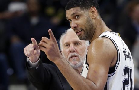 FILE - In this Dec. 2, 2015, file photo, San Antonio Spurs head coach Gregg Popovich, left, talks with forward Tim Duncan (21) during the second half of an NBA basketball game against the Milwaukee Bucks in San Antonio. They were joined at the hip for 19 years, a player and coach combination that enjoyed more wins than any in NBA history. And now that Duncan's playing days are done, Popovich is about to start anew in some respects.  (AP Photo/Eric Gay, File0