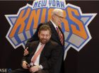 New York Knicks new team president Phil Jackson puts his hand on team owner James Dolan, seated, during a news conference where Jackson was introduced, at New York's Madison Square Garden, Tuesday, March 18, 2014. Jackson signed a five-year contract that will reportedly pay him at least $12 million annually and said he will spend significant time in New York. (AP Photo/Richard Drew)