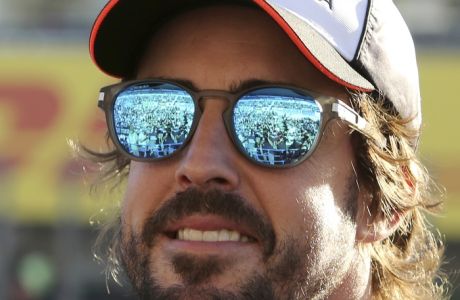 Spectators are reflected on sunglasses of McLaren driver Fernando Alonso of Spain upon his arrival for a fan meeting at the Suzuka Circuit in Suzuka, central Japan, Thursday, Oct. 6, 2016, ahead of Sunday's Japanese Formula One Grand Prix. (AP Photo/Toru Takahashi) 