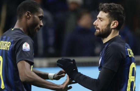 Inter Milan's Antonio Candreva, right, celebrates with teammate Geoffrey Kondogbia after scoring during the Italian Cup Soccer match between Inter Milan and Bologna in Milan, Italy, Tuesday, Jan. 17, 2017. (AP Photo/Luca Bruno)