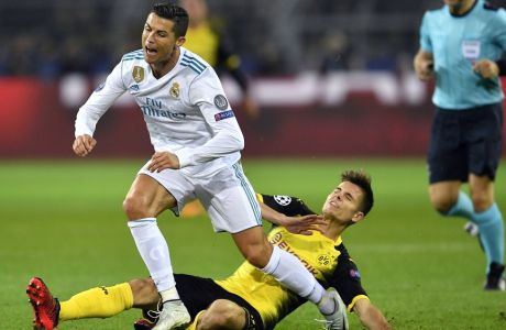 Dortmund's Julian Weigl, bottom, plays foul against Real Madrid's Cristiano Ronaldo, left, during the Champions League group H soccer match between Borussia Dortmund and Real Madrid CF in Dortmund, Germany, Tuesday, Sept. 26, 2017. (AP Photo/Martin Meissner)