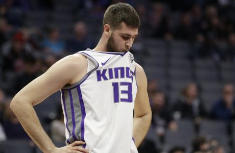 Sacramento Kings center Georgios Papagiannis, of Greece, holds his jersey in his mouth during the closing moments of the Kings' 131-111 loss to the Charlotte Hornets in an NBA basketball game Tuesday, Jan. 2, 2018, in Sacramento, Calif. (AP Photo/Rich Pedroncelli)