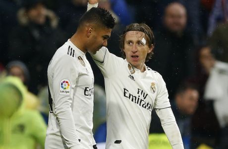 Real Madrid's Luka Modric, right, celebrates his goal with his teammate Casemiro during the La Liga soccer match between Real Madrid and Sevilla at the Bernabeu stadium in Madrid, Spain, Saturday, Jan. 19, 2019. (AP Photo/Andrea Comas)