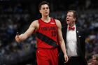 Portland Trail Blazers coach Terry Stotts, right, confers with forward Zach Collins, who heads to the bench after being called for a foul against the Denver Nuggets during the second half of Game 2 of an NBA basketball second-round playoff series Wednesday, May 1, 2019, in Denver. Portland won 97-90. (AP Photo/David Zalubowski)