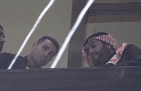 Al Nassr's Cristiano Ronaldo watches the Riyadh Season Cup soccer match between Inter Miami and Al Nassr at Kingdom Arena Stadium in Riyadh, Saudi Arabia, Thursday, Feb. 1, 2024. (AP Photo/Amr Nabil)
