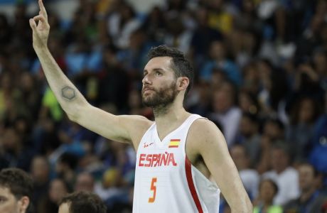 Spain's Rudy Fernandez (5) celebrates on the bench during a basketball game against Lithuania at the 2016 Summer Olympics in Rio de Janeiro, Brazil, Saturday, Aug. 13, 2016. (AP Photo/Charlie Neibergall)