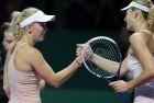 Denmark's Caroline Wozniacki, left, is congratulated by Russia's Maria Sharapova after winning their singles match at the WTA tennis finals in Singapore,Tuesday, Oct. 21, 2014. (AP Photo/Mark Baker)