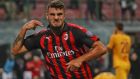 AC Milan's Patrick Cutrone celebrates after scoring his side's 2nd goal during the Serie A soccer match between AC Milan and Roma at the Milan San Siro Stadium, Italy, Friday, Aug. 31, 2018. (AP Photo/Antonio Calanni)