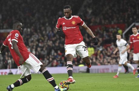 Manchester United's Eric Bailly, left, and Manchester United's Aaron Wan-Bissaka in action during the English Premier League soccer match between Manchester United and Burnley at Old Trafford in Manchester, England, Thursday, Dec. 30, 2021. (AP Photo/Rui Vieira)
