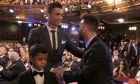 Portuguese soccer player Ronaldo, left, shakes hands wit Argentinian soccer player Lionel Messi during the The Best FIFA 2017 Awards at the Palladium Theatre in London, Monday, Oct. 23, 2017. (AP Photo/Alastair Grant)