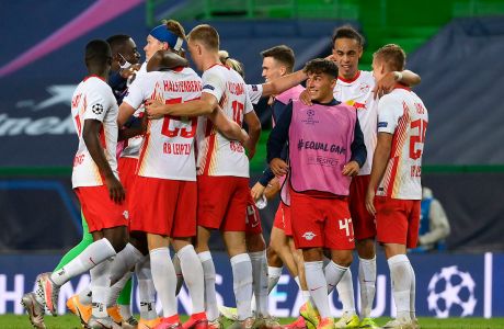 RB Leipzig players celebrate after winning their Champions League quarterfinal match against Atletico Madrid at the Jose Alvalade stadium in Lisbon, Portugal, Thursday, Aug. 13, 2020. (Lluis Gene/Pool Photo via AP)