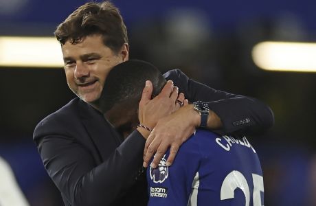 Chelsea's Moises Caicedo is embraced by head coach Mauricio Pochettino after their win in the English Premier League soccer match between Chelsea and Luton Town at Stamford Bridge stadium in London, Saturday, Aug. 26, 2023. (AP Photo/Ian Walton)