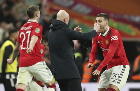 Manchester United's head coach Erik ten Hag, centre, Manchester United's Diogo Dalot, right, and Manchester United's Wout Weghorst celebrate after winning the English League Cup final soccer match between Manchester United and Newcastle United at Wembley Stadium in London, Sunday, Feb. 26, 2023. Manchester United won 2-0. (AP Photo/Scott Heppell)
