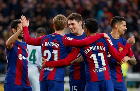 Barcelona's Frenkie de Jong celebrates with teammates after scoring his side's third goal during a Spanish La Liga soccer match between Barcelona and Getafe at the Olimpic Lluis Companys stadium in Barcelona, Spain, Saturday, Feb. 24, 2024. (AP Photo/Joan Monfort)