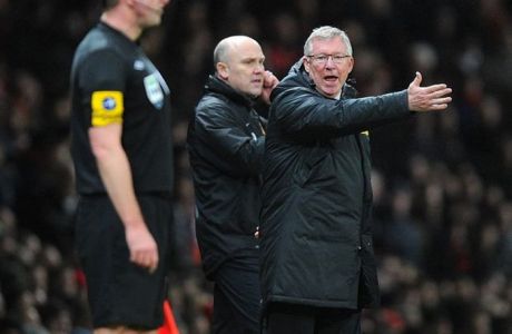 Manchester United manager Sir Alex Ferguson gestures towards the assistant referee on the touchline