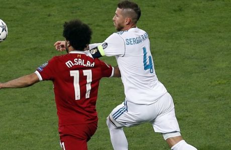 Liverpool's Mohamed Salah, left, and Real Madrid's Sergio Ramos, right, challenge for the ball during the Champions League Final soccer match between Real Madrid and Liverpool at the Olimpiyskiy Stadium in Kiev, Ukraine, Saturday, May 26, 2018. (AP Photo/Darko Vojinovic)
