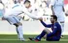 Real Madrid's Cristiano Ronaldo, left, helps Barcelona's Lionel Messi get back on his feet during the Spanish La Liga soccer match between Real Madrid and Barcelona at the Santiago Bernabeu stadium in Madrid, Spain, Saturday, Dec. 23, 2017. (AP Photo/Francisco Seco)