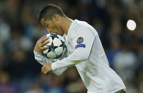 Real Madrid's Cristiano Ronaldo kisses the ball after scoring a penalty during a Group H Champions League soccer match between Real Madrid and Tottenham Hotspur at the Santiago Bernabeu stadium in Madrid, Tuesday Oct. 17, 2017. (AP Photo/Paul White)