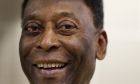 FILE - Brazilian soccer legend Pele smiles during a media opportunity at a restaurant in London, March 20, 2015. Pelé, the Brazilian king of soccer who won a record three World Cups and became one of the most commanding sports figures of the last century, died in Sao Paulo on Thursday, Dec. 29, 2022. He was 82. (AP Photo/Kirsty Wigglesworth, File)