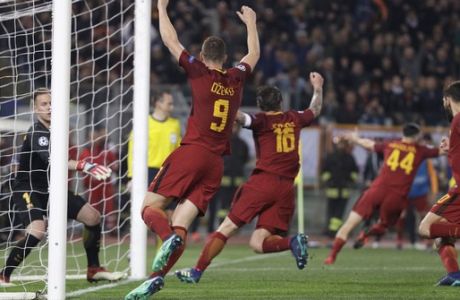 Roma players celebrate with teammate Kostas Manolas, second right, after he scored his side's third goal during the Champions League quarterfinal second leg soccer match between between Roma and FC Barcelona, at Rome's Olympic Stadium, Tuesday, April 10, 2018. (AP Photo/Gregorio Borgia)