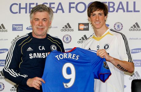 Chelsea's new signing Spain striker Fernando Torres, right, poses for a photograph with manager Carlo Ancelotti during a press conference at the club's training ground in Cobham, England, Friday, Feb. 4, 2011. (AP Photo/Kirsty Wigglesworth)