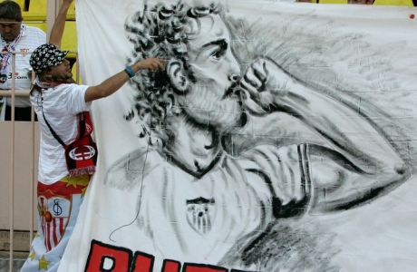 Sevilla's supporter holds a banner in memory of the Sevilla's soccer player Antonio Puerta, who collapsed on Saturday and died on Tuesday in Spain , before the UEFA Super Cup finale match Milan vs Sevilla, Friday, Aug. 31, 2007, in Monaco stadium. (AP Photo/Lionel Cironneau)